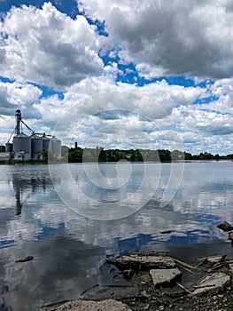 Gain Bins and Clouds and Blue Sky reflecting in the Lake