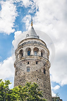 Galata Tower on a cloudy summer day, one of the main landmarks of Istanbul, Turkey