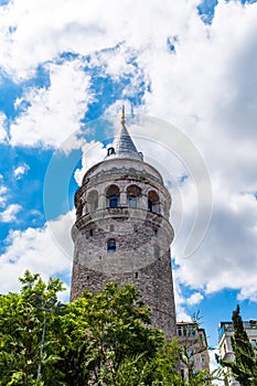 Galata Tower on a cloudy summer day, one of the main landmarks of Istanbul, Turkey