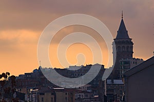 Galata Tower, in Istambul, Turkey, silhouetted against the twilight sky.