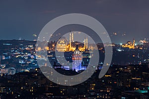 Galata Tower and Suleymaniye Mosque at night in Istanbul, Turkey