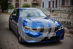 Galati, Romania - July 4, 2020: 2020 Blue BMW 3 Series G20 M340i xDrive Steptronic front and side view on a street