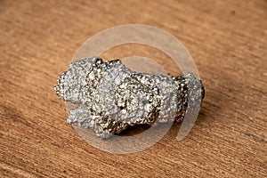 Galenit gemstone gem jewel mineral precious stone sparkling in silver on wooden underground