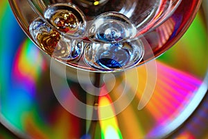 Galileo temperature light bulb on a cd disk with wonderful colours - stock photo