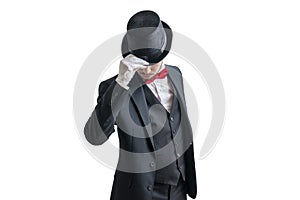 Gallant magician or illusionist in suit is taking off his hat. Isolated on white background photo