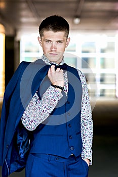 Gallant serious man in blue suit