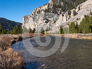 Gallatin River with Autumn Vegetation and Rocky Cliffs photo