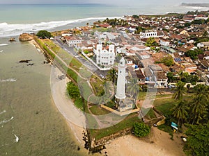 Aerial view of Galle lighthouse and Galle fort walls in the Bay of Galle on the southwest coast of Sri Lanka.