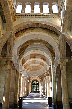 Gallery of columns and arches, built of light stone, ending with a window