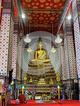 Gallery with old vessels of the seated Buddha in the Buddhist temple Wat Arun. Bangkok, Thailand