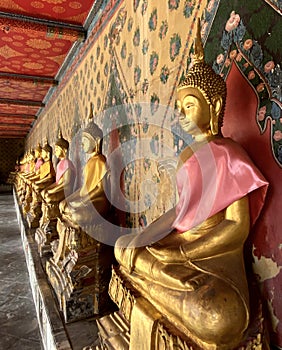 Gallery with old vessels of the seated Buddha in the Buddhist temple Wat Arun. Bangkok, Thailand