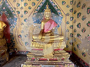 Gallery with old vessels of the seated Buddha in the Buddhist temple Wat Arun. Bangkok, Thailand