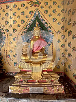 Gallery with old vessels of the seated Buddha in the Buddhist temple Wat Arun. Bangkok, Thailand