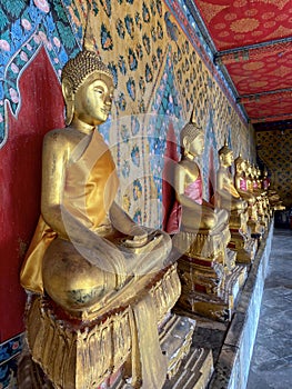 Gallery with old vessels of the seated Buddha in the Buddhist temple Wat Arun. Bangkok, Thailand