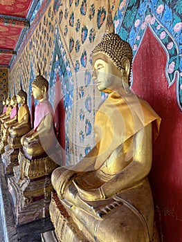 Gallery with old vessels of the seated Buddha in the Buddhist temple Wat Arun. Bangkok, Thailand