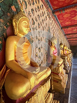 Gallery with old vessels of the seated Buddha in the Buddhist temple Wat Arun. Bangkok, Thailand