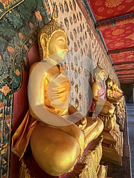 Gallery with old vessels of the seated Buddha in the Buddhist temple Wat Arun. Bangkok, Thailand