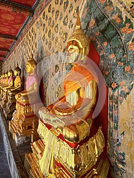 Gallery with old vessels of the seated Buddha in the Buddhist temple Wat Arun. Bangkok, Thailand