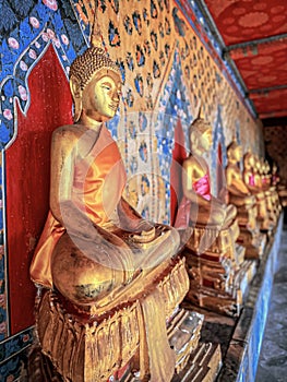 Gallery with old vessels of the seated Buddha in the Buddhist temple Wat Arun. Bangkok, Thailand