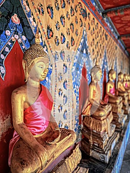 Gallery with old vessels of the seated Buddha in the Buddhist temple Wat Arun. Bangkok, Thailand