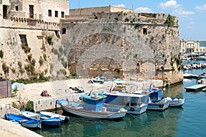 Gallipoli, Angevin castle with fishing boats photo