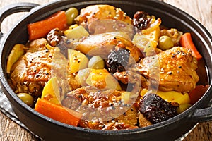 Gallo en chicha is a rooster cooked in a fermented corn drink with vegetable and spices closeup on the pan. Horizontal photo