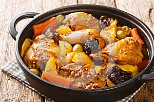 Gallo en chicha stew with chicken, prunes, vegetables, and spices cooked to have a wonderful flavor and aroma closeup on the pan.