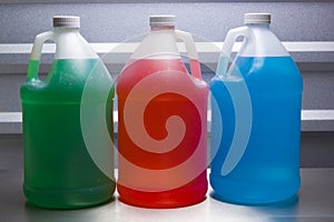 Gallon containers with colored liquid