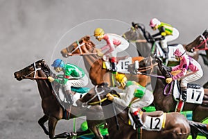 Galloping jockeys and race horses toy competing for position.Concept to compete for victory