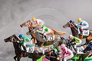 Galloping jockeys and race horses toy competing for position.Concept to compete for victory