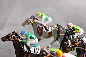 Galloping jockeys and race horses toy competing for position.Concept to compete for victory