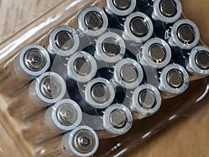 Galvanic cells, batteries in the package, in rows, at an angle on the background of the table. Background with