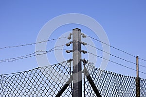 Galvanised barbed wire mesh fence photo