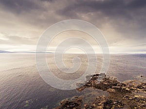 Galway bay, Atlantic ocean, Two sides of the coast. Burren in the background. Dramatic cloudy sky. Aerial view