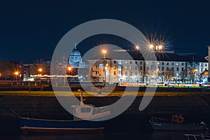 Galway, Ireland - 12.04.2021: Night scene. Jurys Inn and Galway Cathedral illuminated at night. Christmas time season