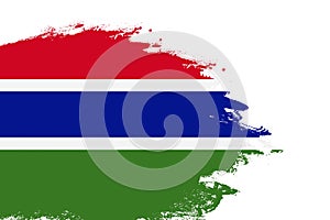 Gambia flag on a stained stroke brush painted isolated white background with copy space