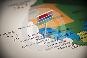 Gambia marked with a flag on the map