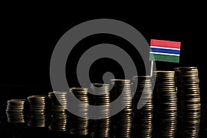 Gambian flag with lot of coins isolated on black