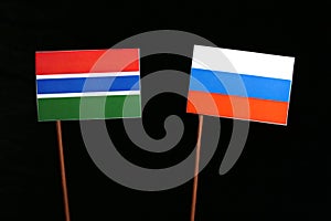 Gambian flag with Russian flag isolated on black
