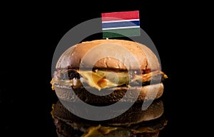 Gambian flag on top of hamburger isolated on black
