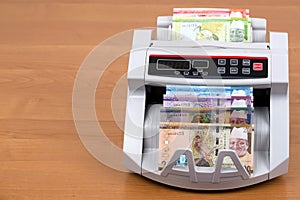 Gambian money - dalasi in a counting machine
