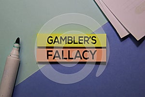 Gambler`s Fallacy text on sticky notes isolated on office desk Concept