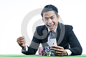 The gambler is very happy to win poker cards and recieve bet a l