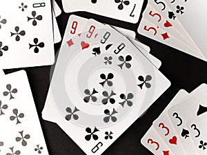 gambling card game. cards tens nines black and red diamonds worms clubs and spades on a dark background