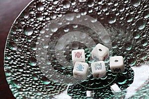 Gambling, five poker dices in a glass bowl