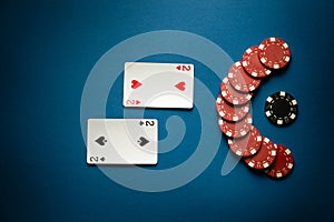 Gambling game of poker with a winning combination of one pair. Cards with chips on a blue table in a poker club. Advertising space