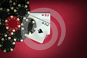 A gambling game of poker with a winning combination of one pair. Cards with chips on a red table in a poker club. Space for