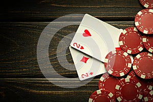 Gambling poker with a winning combination of one pair. Cards with chips on a black vintage table in a poker club