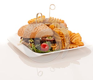 Gamburger with frenchfries on a plate isolated over white background
