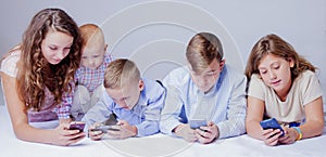 Game addiction concept. Group of kids using electronic devices.